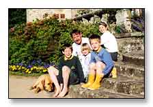 The family on the front steps, with the tower behind